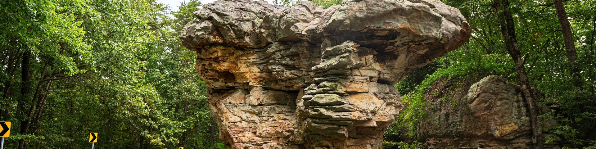 Looking east to west, Mushroom Rock appears to be two mushrooms clustered together. The national landmark sits at the center of the road on the Little River Canyon Rim Parkway in Alabama.