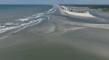 Vast sandbar at North end of Cherry Grove Beach where people sunbath on beautiful beach while on summer vacation at North Myrtle Beach in South Carolina