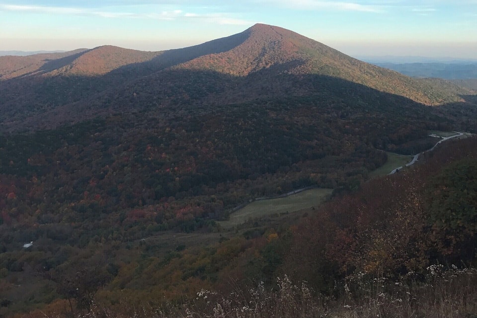 A mountain range with a valley and a river.