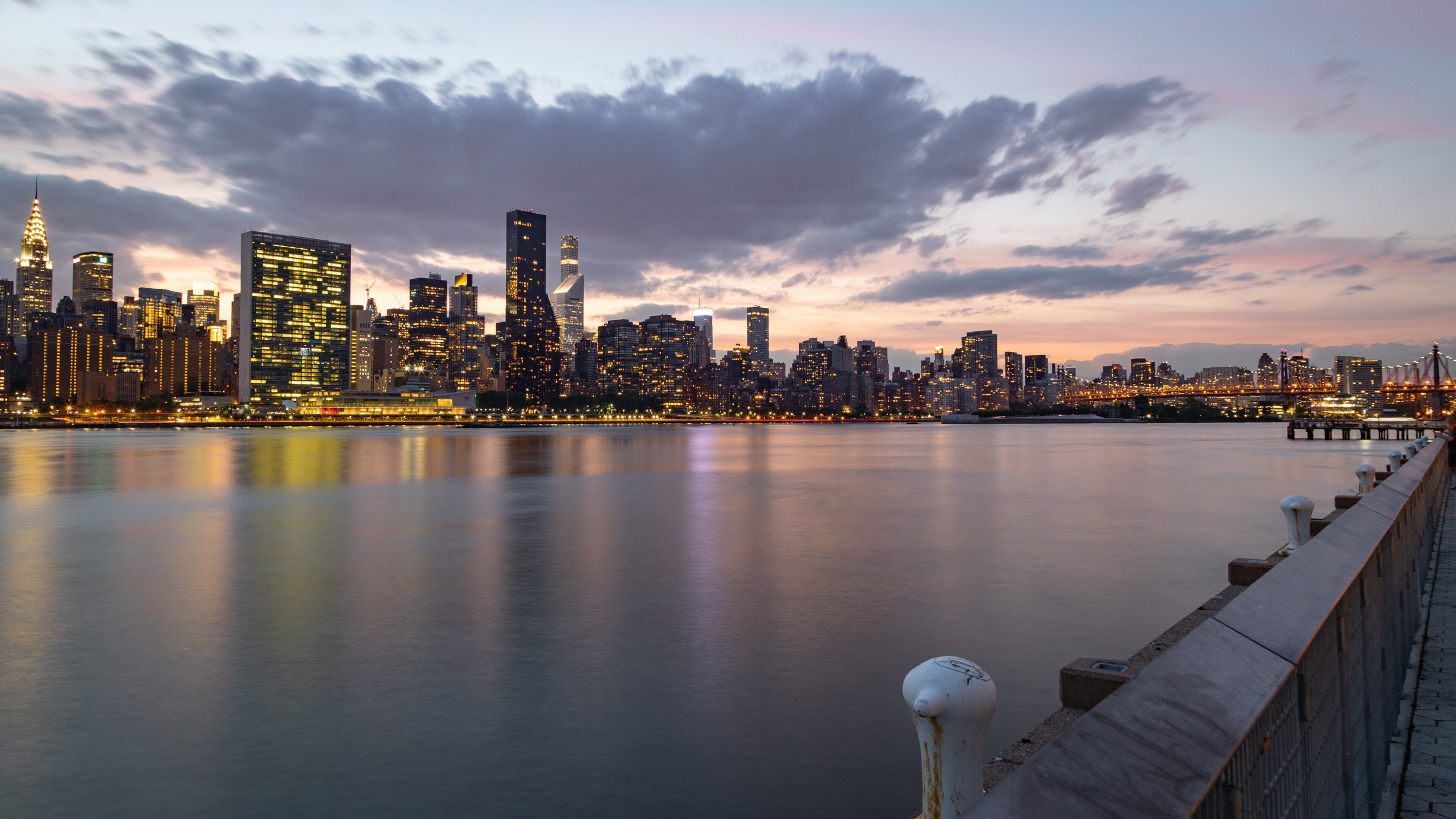 Hunter\'s Point South which includes a sunset, a bay or harbor and a city