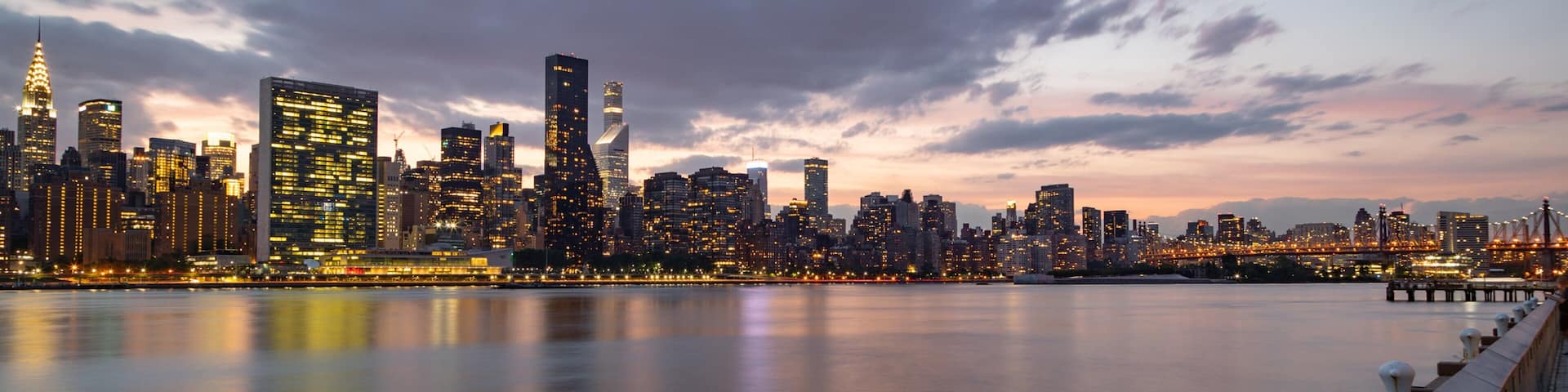 Hunter\'s Point South which includes a sunset, a bay or harbor and a city