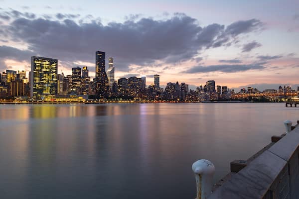 Hunter\'s Point South which includes a sunset, a bay or harbor and a city