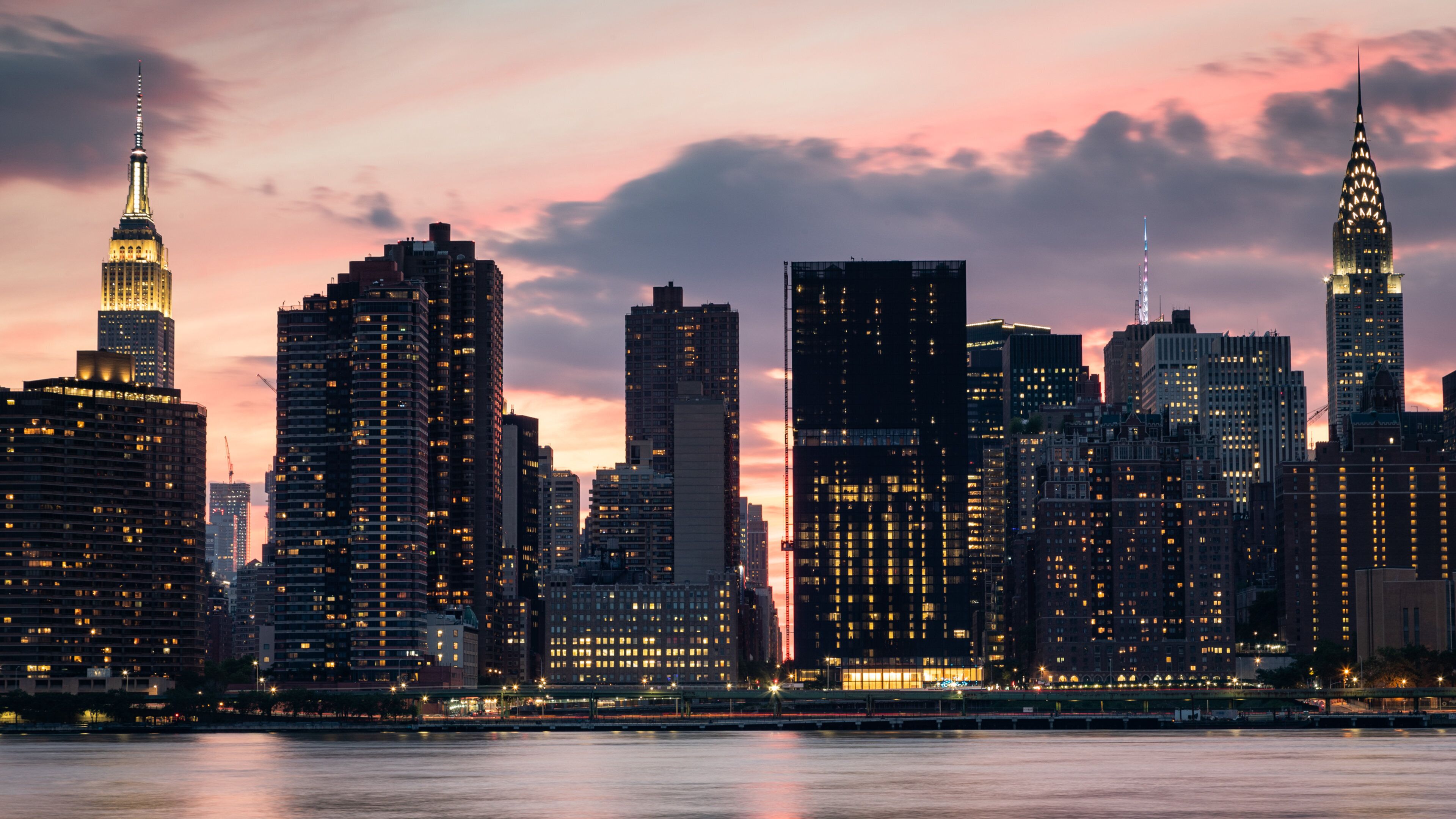 Hunter\'s Point South which includes a sunset, a city and a bay or harbor