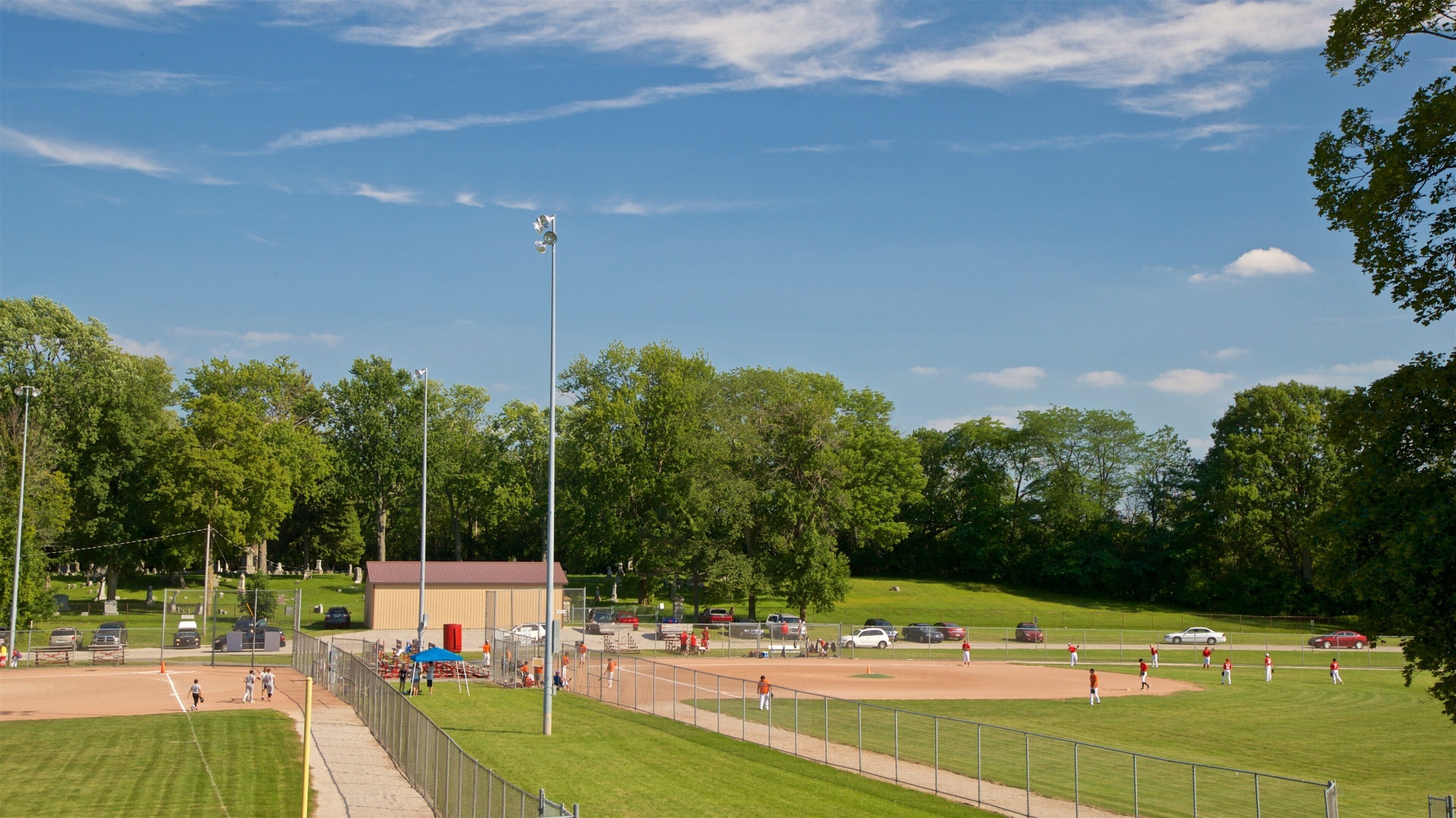 Hoyt Park which includes a park and a sporting event as well as a small group of people