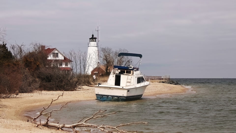 a beached boat at cove point lighthouse in lusby, maryland