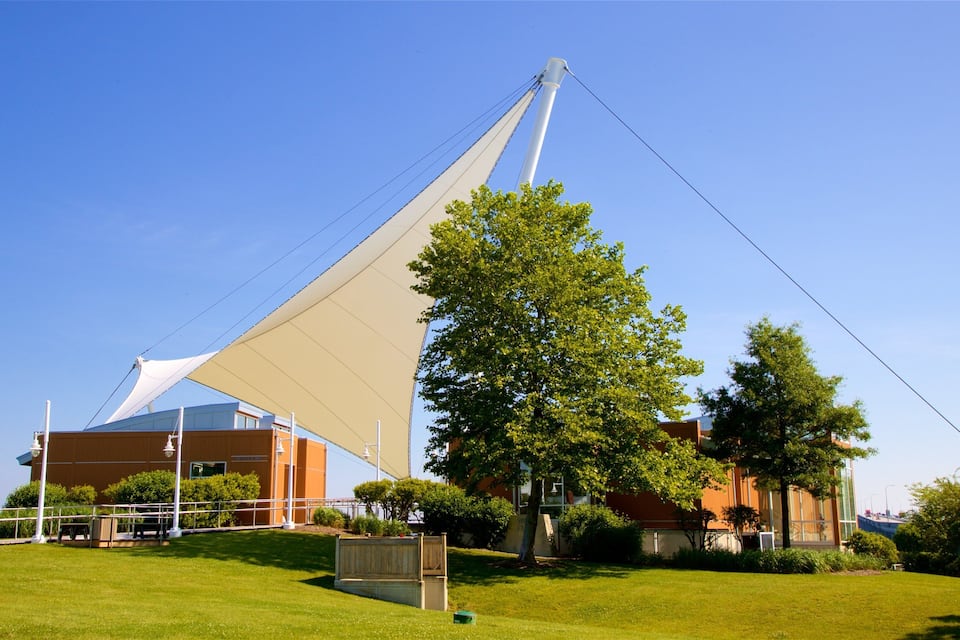 A modern building with a large sail-like structure.