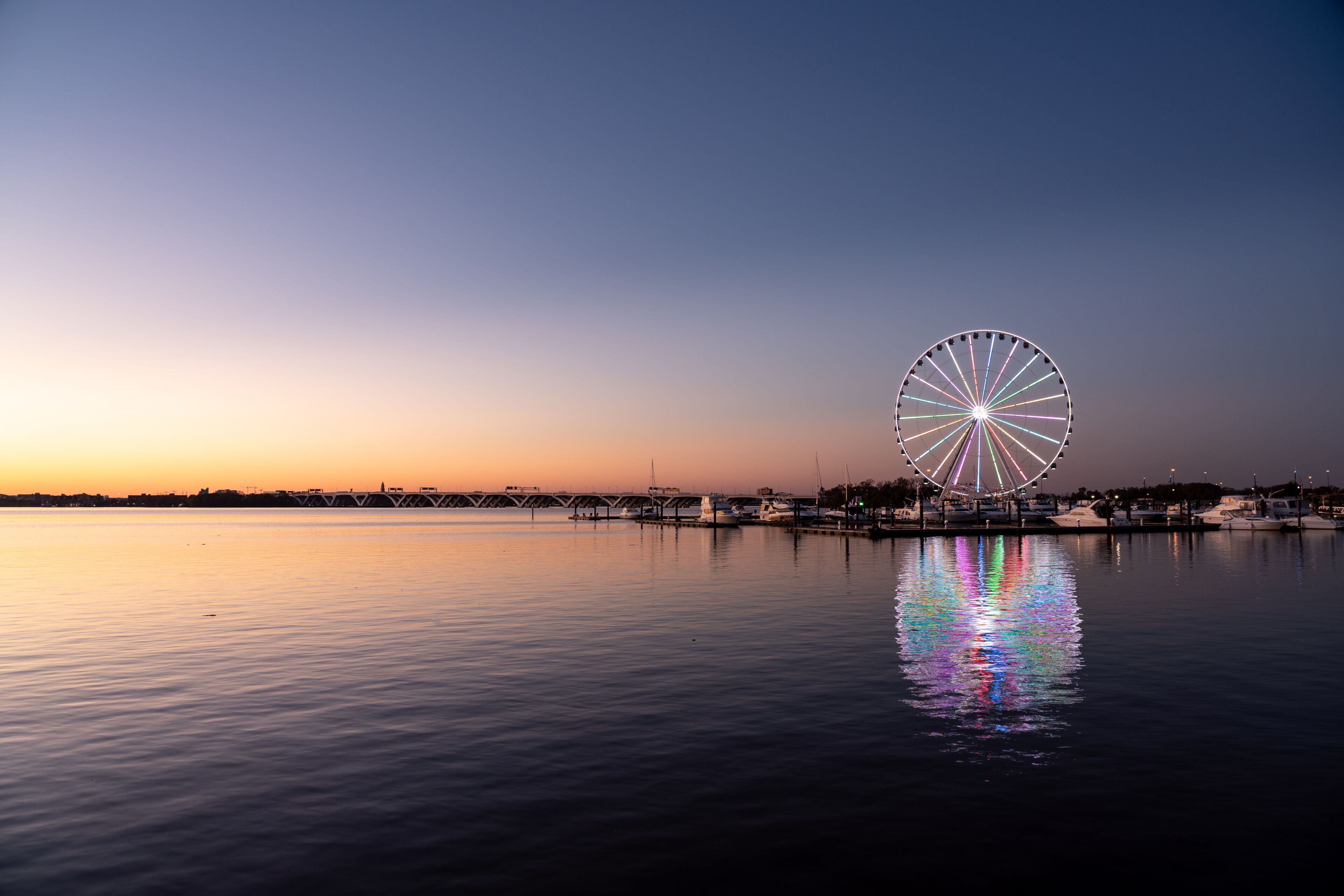 Illuminated ferris wheel at National Harbor near the nation capital of Washington DC at sunset