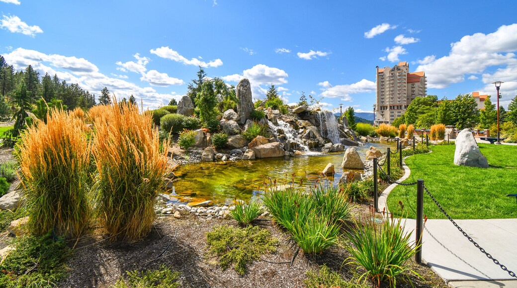 A large pond with waterfall inside the public McEuen Park near resorts and Tubbs Hill in the lakefront town of Coeur d'Alene, Idaho.