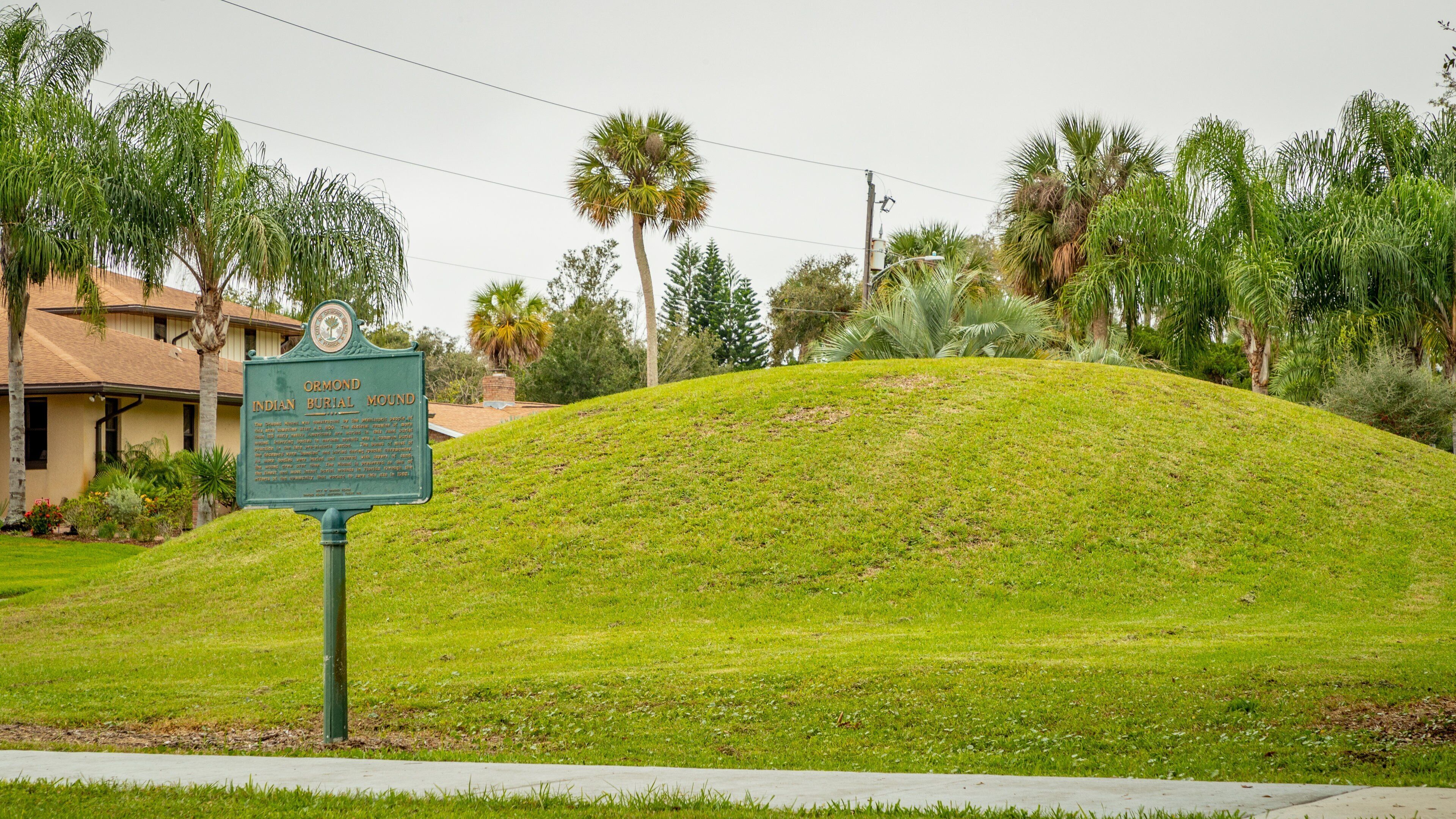 Ormond Mound featuring signage and a garden