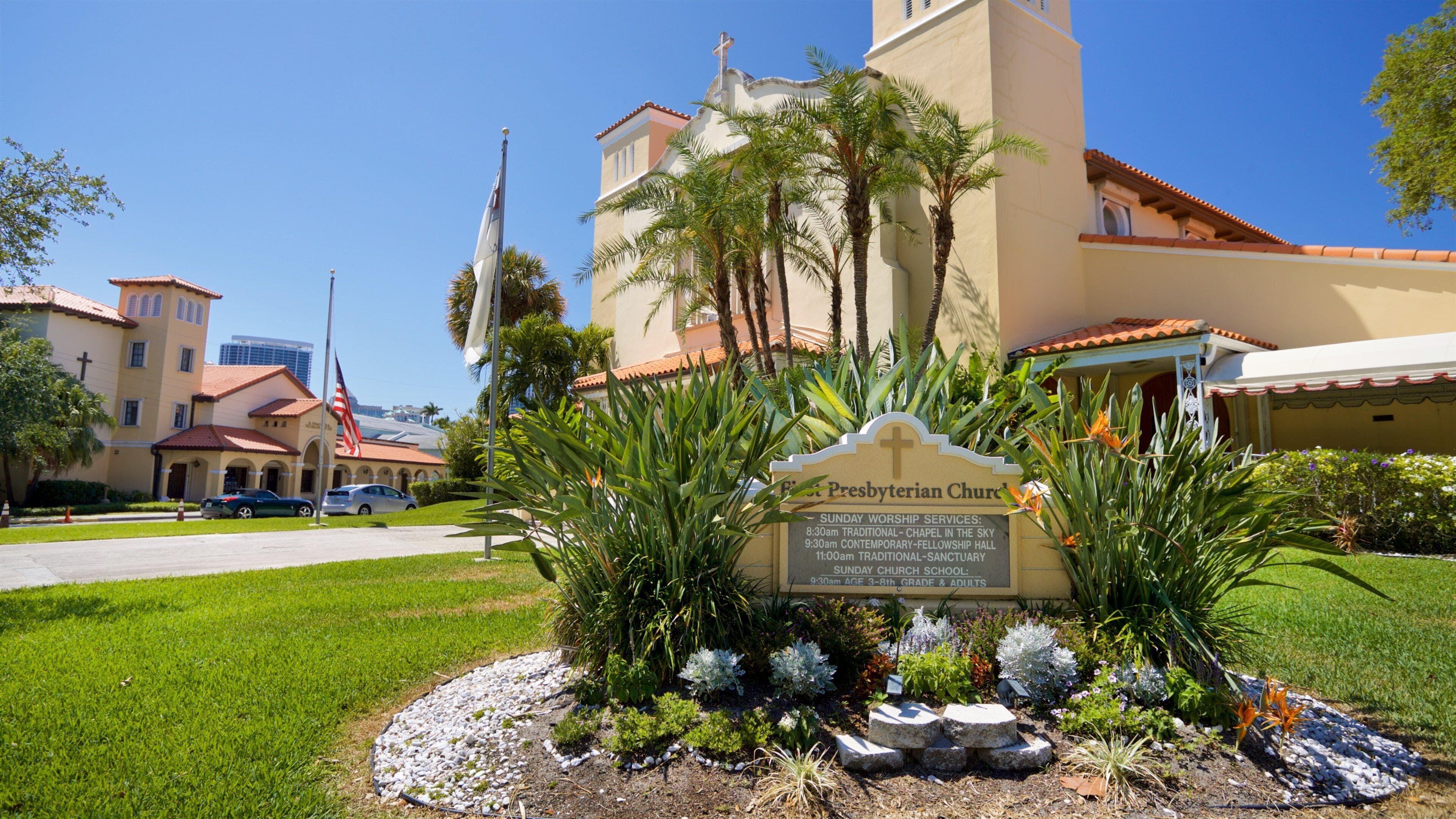First Presbyterian Church featuring a church or cathedral, signage and flowers