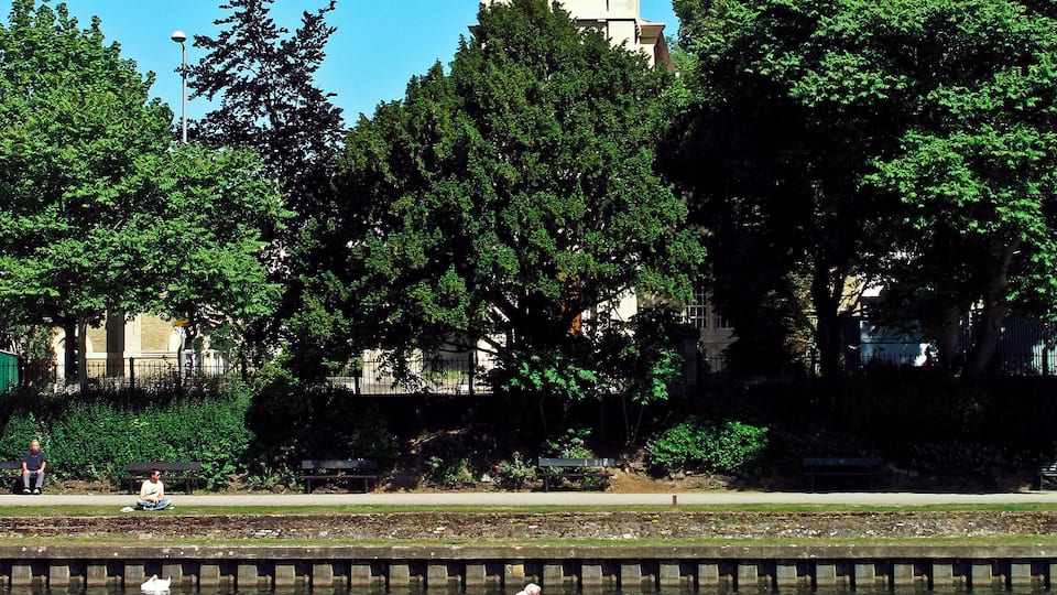 View east across the River Thames from Barge Walk, Kingston-upon-Thames to St Raphael's parish church, Surbiton
