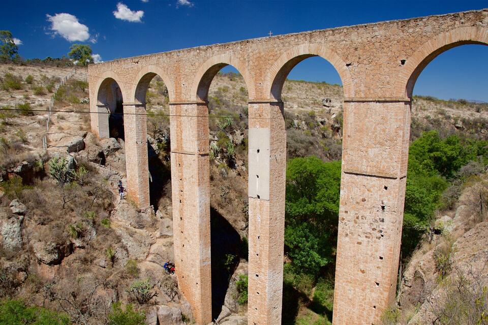 A stone viaduct with multiple arches over a rocky terrain.