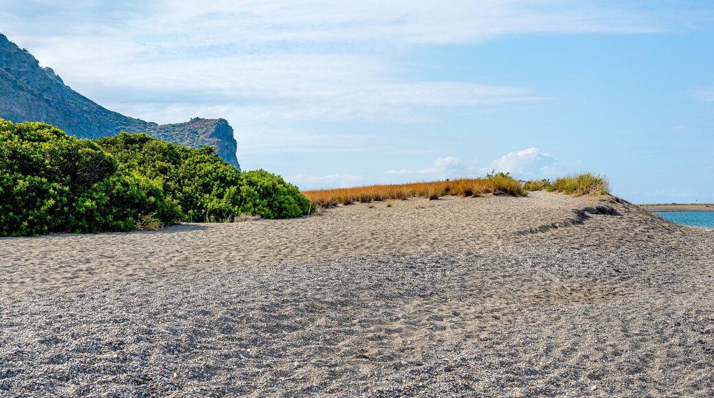Lakes of Marinello Sicily Italy. Panorama of the coastline from the natural reserve with a salty lake on the right and mountains along the sea.