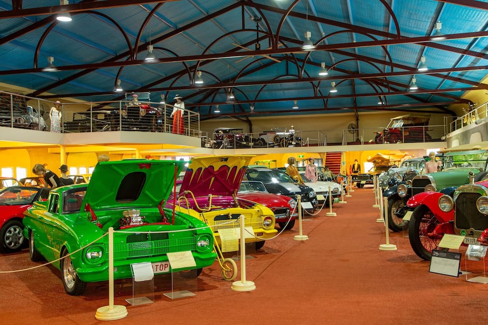 A vintage car exhibition with various classic cars on display.