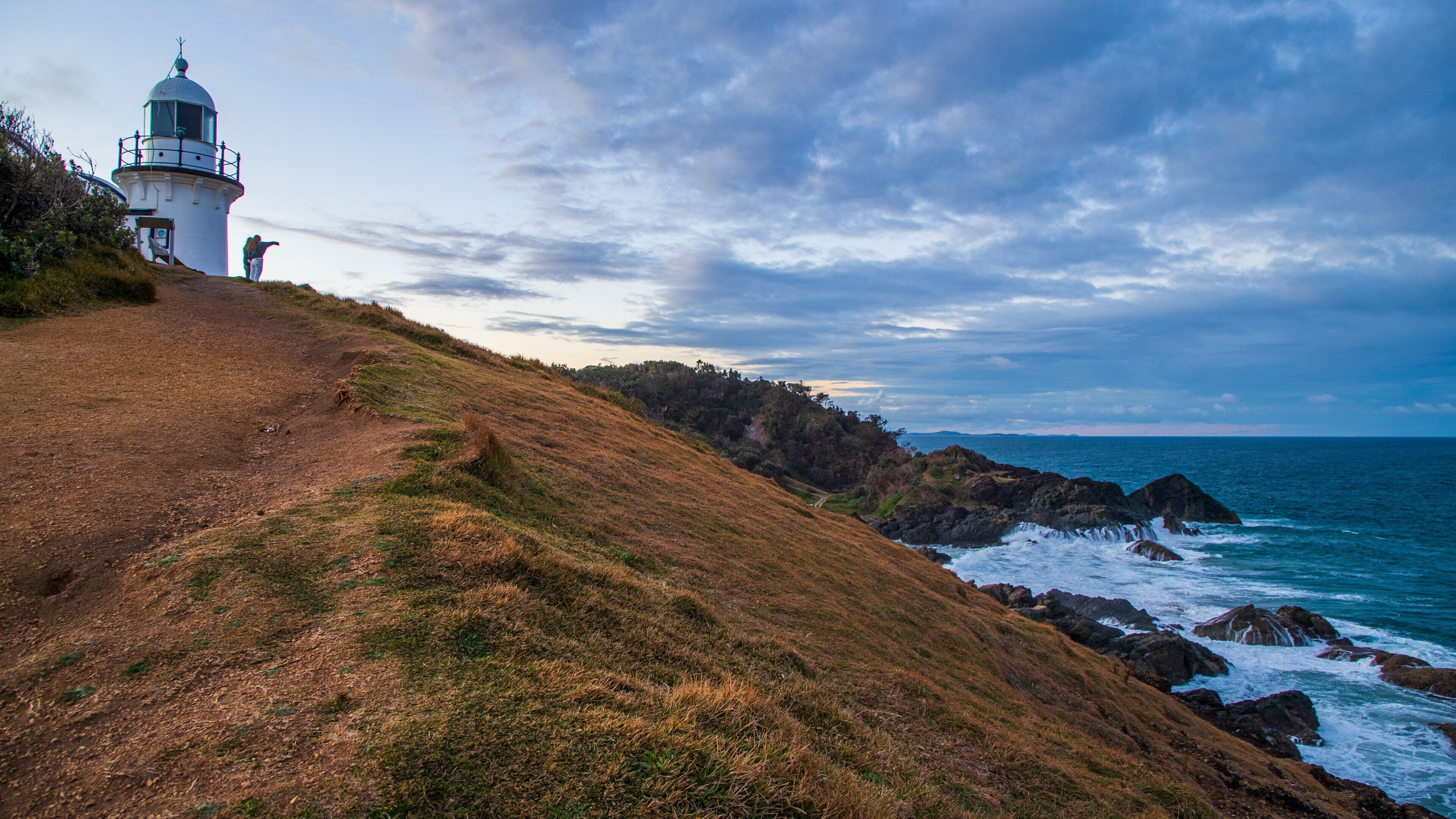 Tacking Point Lighthouse featuring a lighthouse, rocky coastline and general coastal views