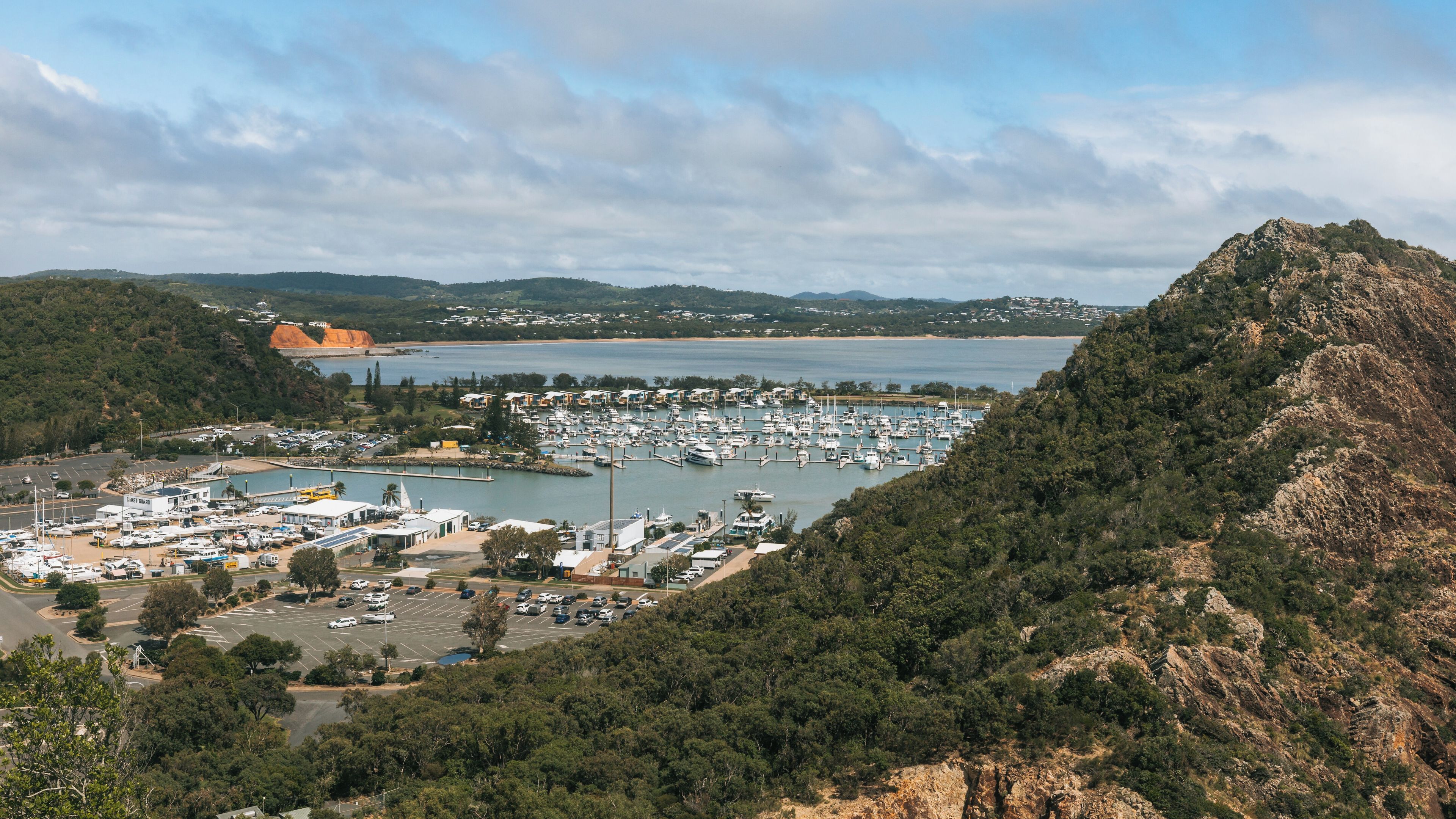 A marina surrounded by hills and a body of water.
