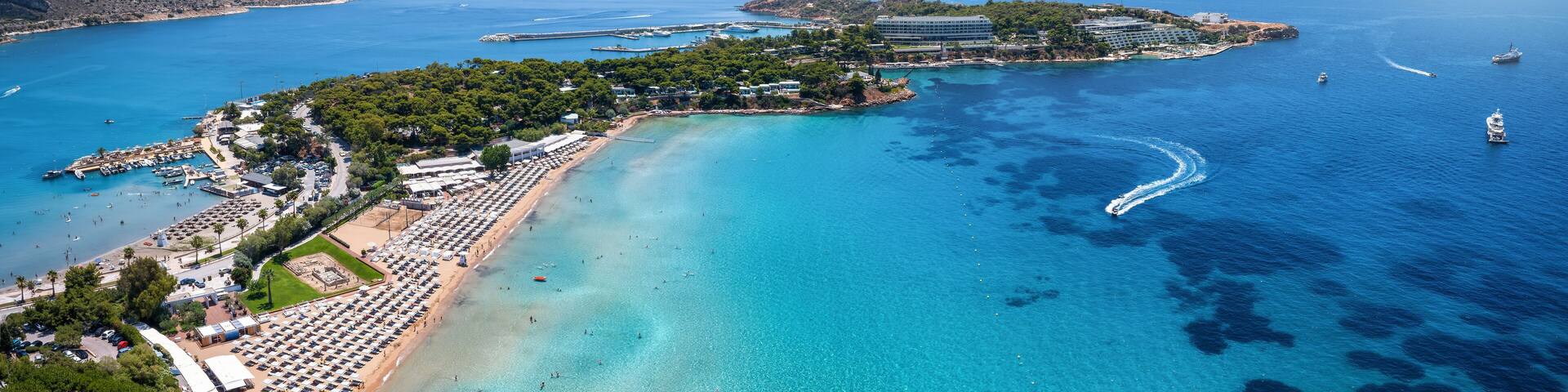 Aerial view of the beautiful beach of Astir at the bay of Vouliagmeni, Athens, with turquoise and emerald sea