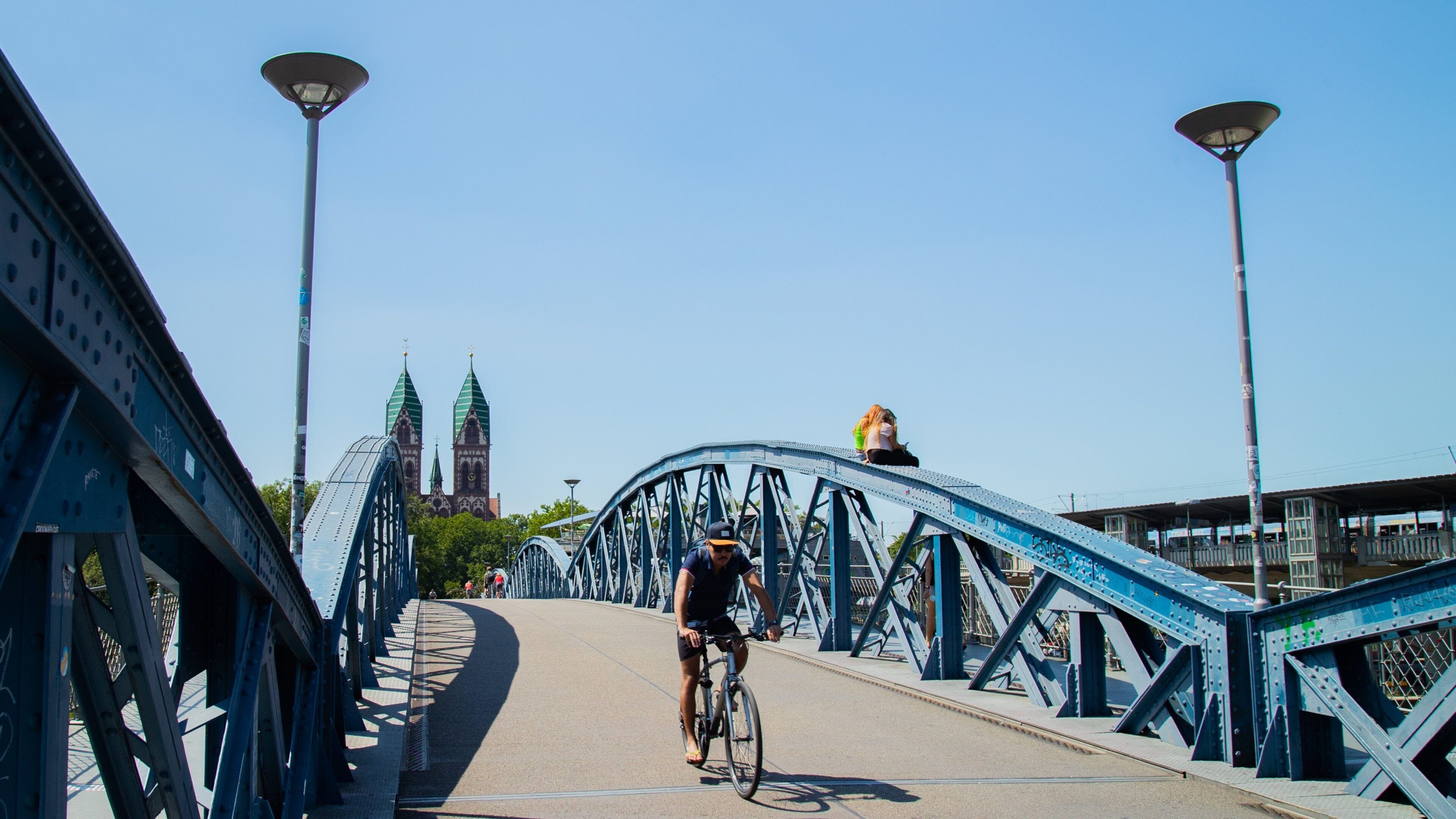 Blue Bridge featuring a bridge and cycling as well as an individual male