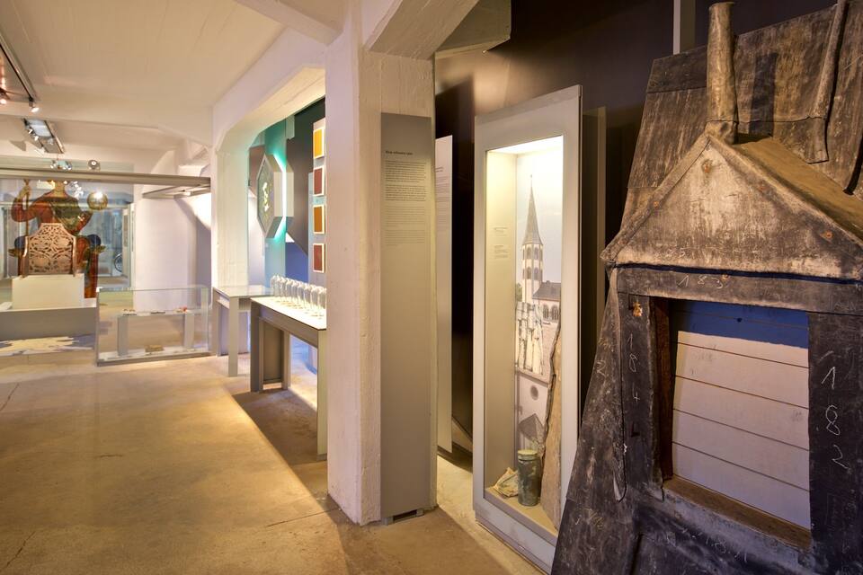 An indoor museum exhibit with glass display cases and informational plaques.