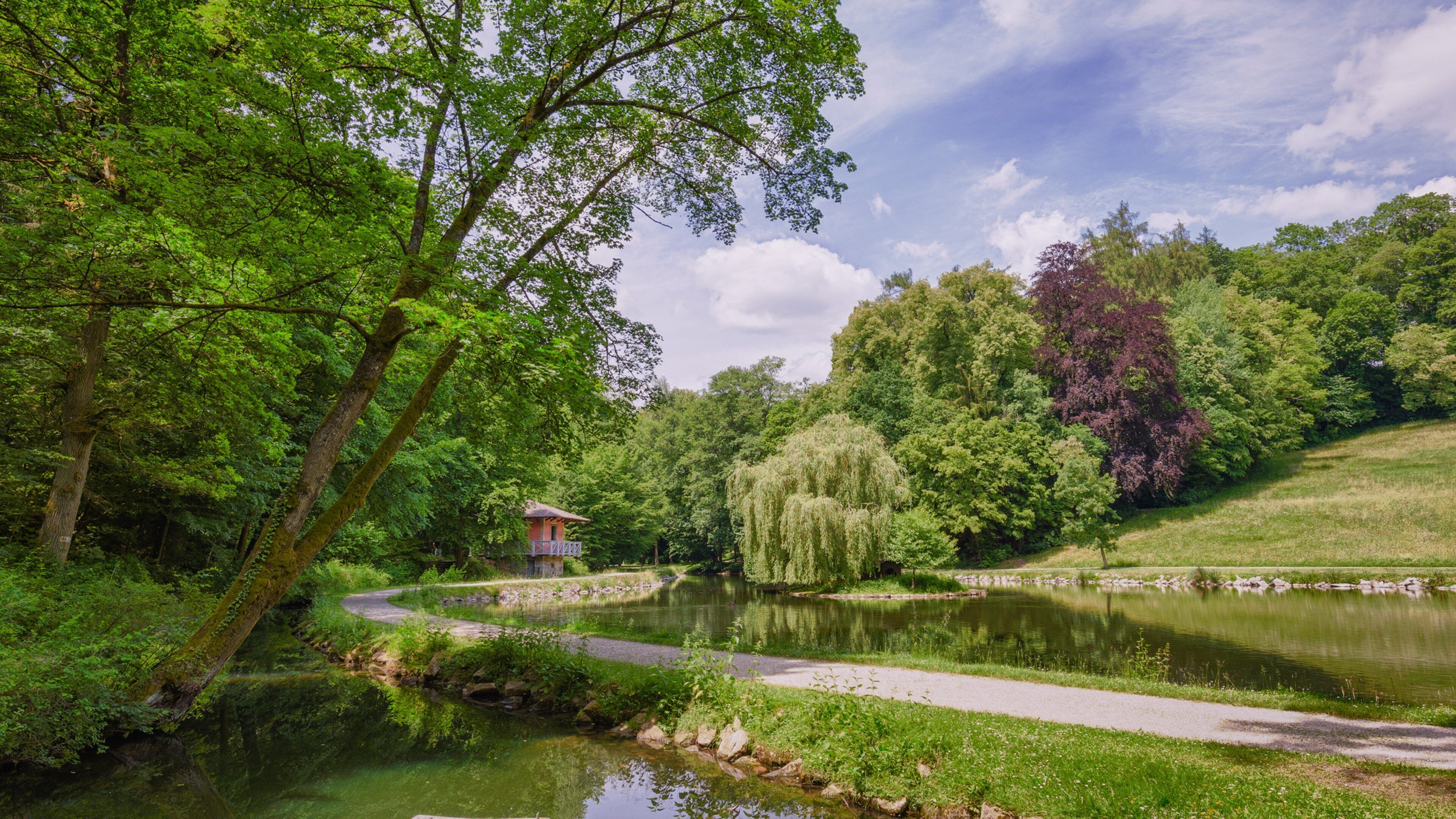 Fantaisie Palace featuring a pond and a garden