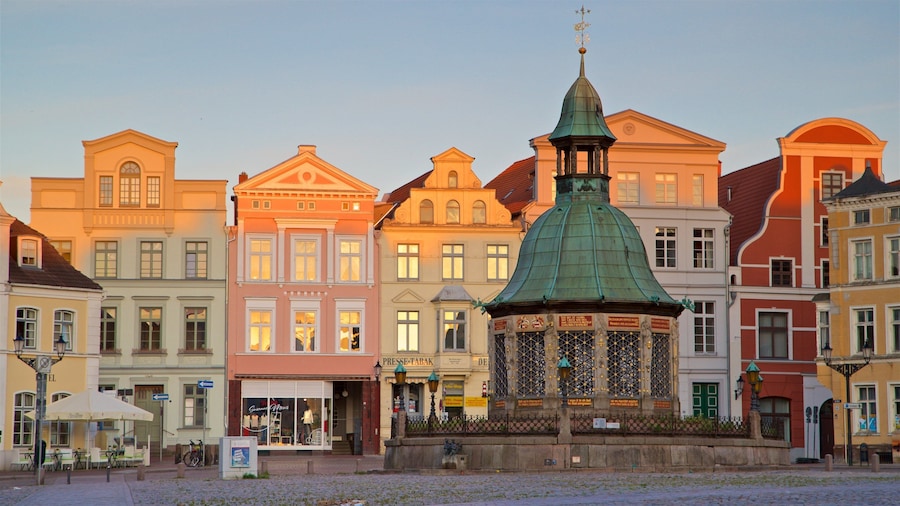 Wasserkunst featuring heritage elements, a city and a sunset