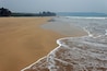 Guhagar beach view with small waves and large expanse of sand. Ratnagiri Konkan, Maharashtra, India.