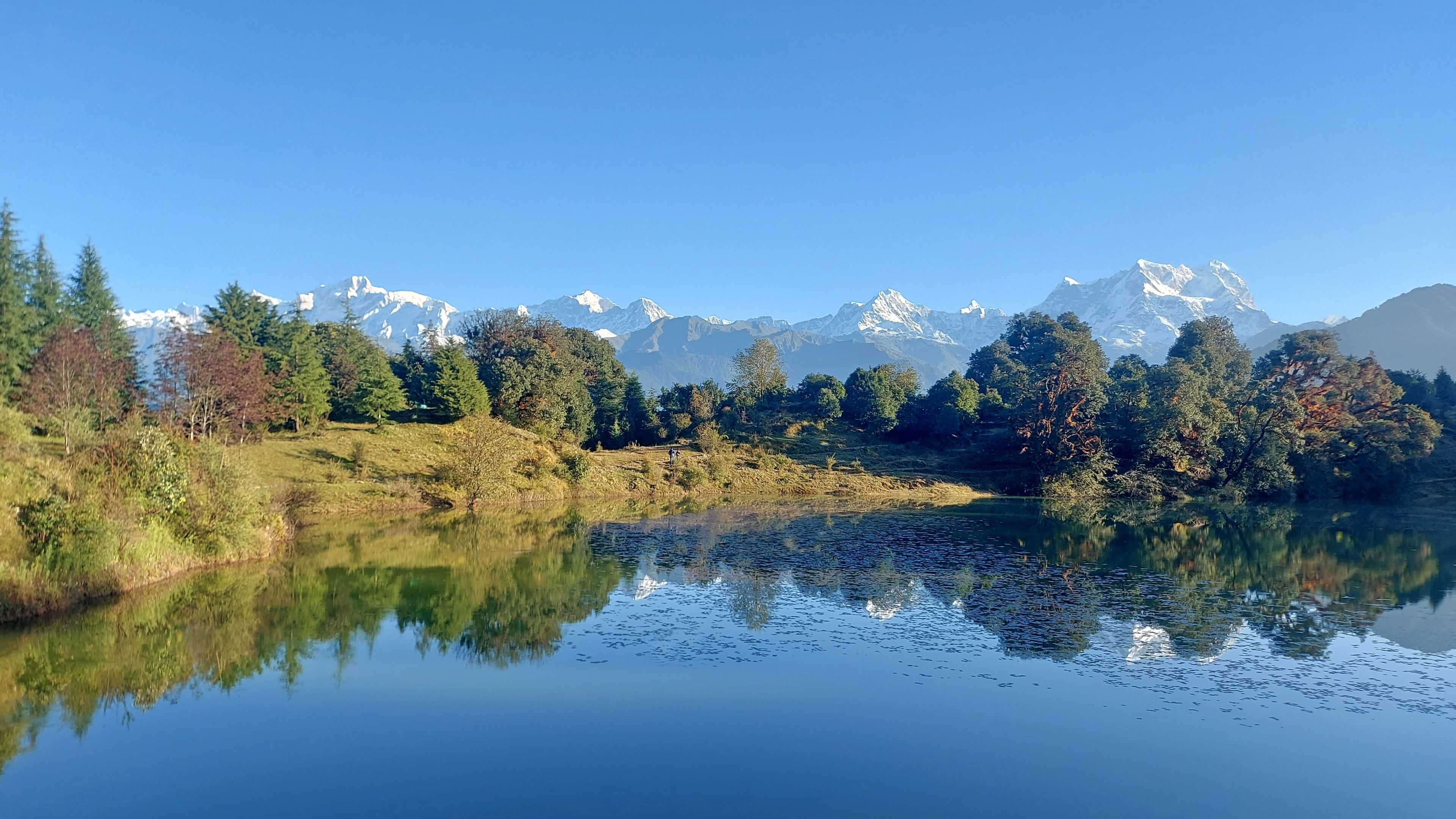 Scenic Morning Reflection of Chaukhamba and Himalayan Peaks in Deoria Taal Lake, Uttarakhand