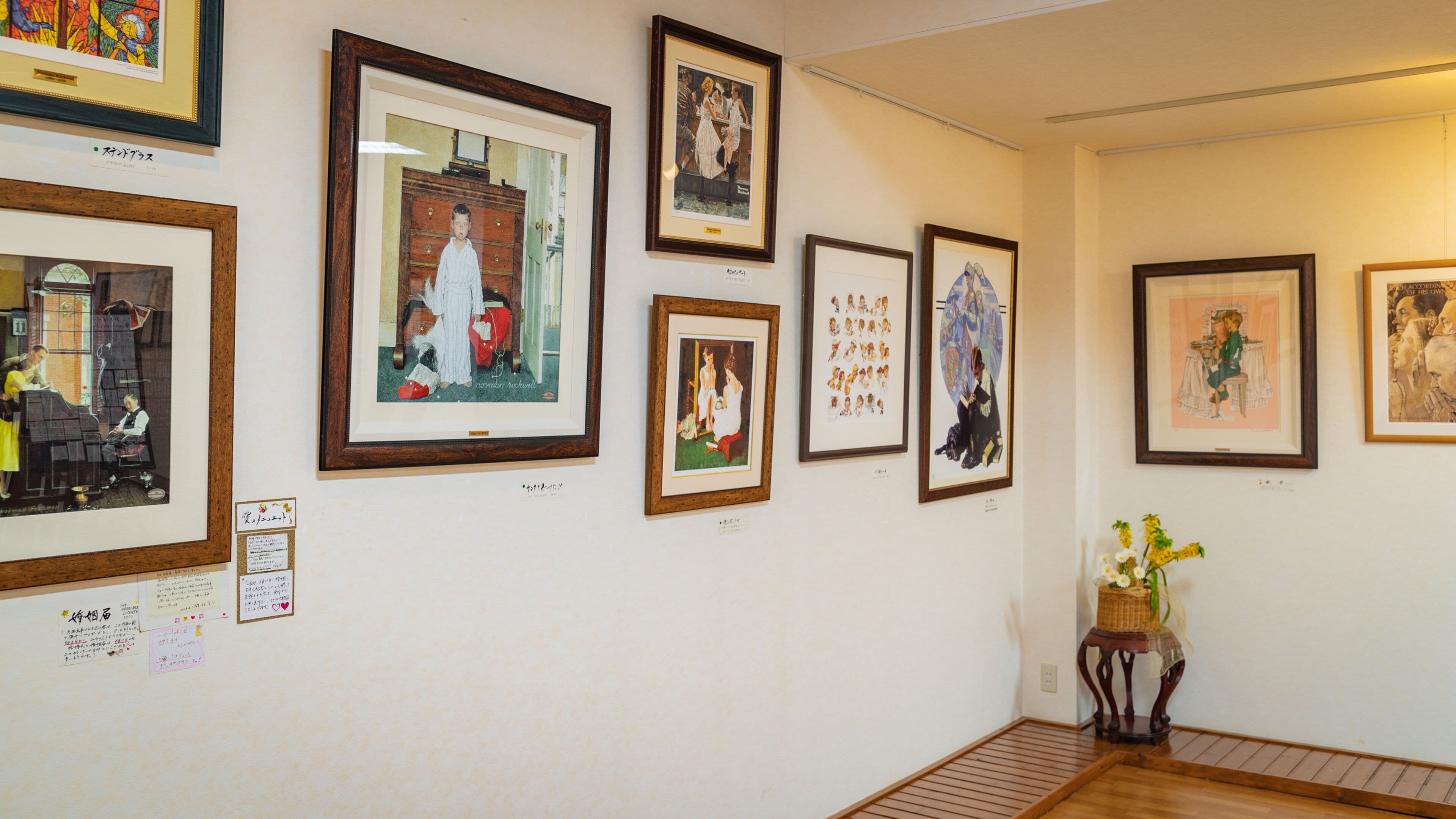 A gallery wall with various framed artworks.