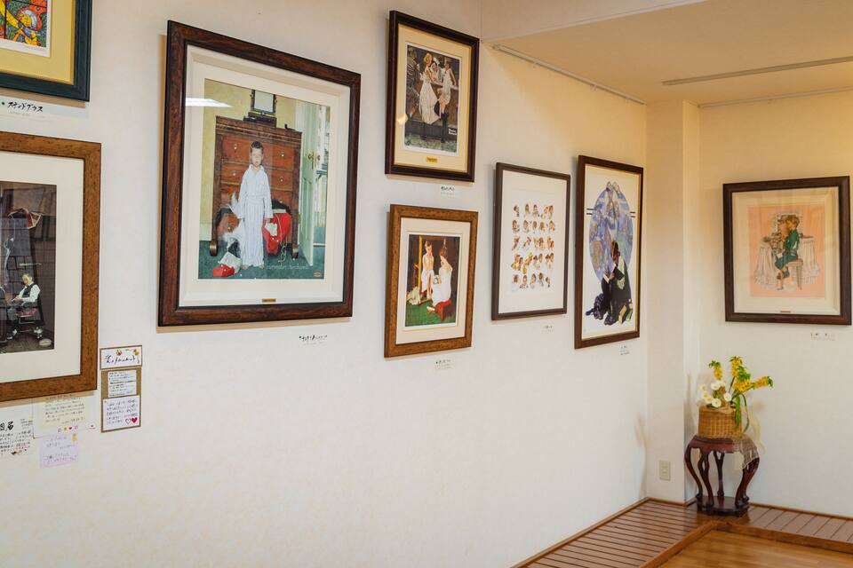 A gallery wall with various framed artworks.
