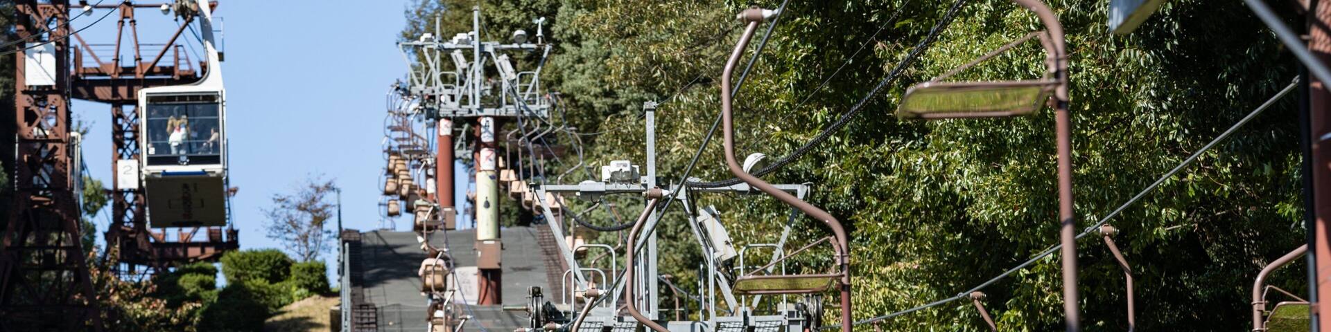 A cable car system with passengers and empty seats.