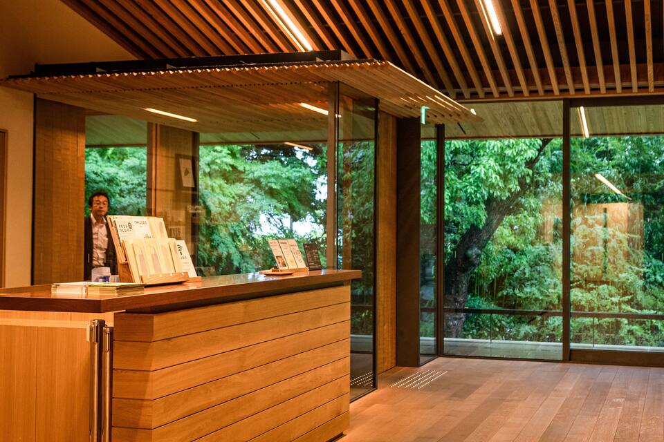 A reception desk with wooden panels and a glass window.