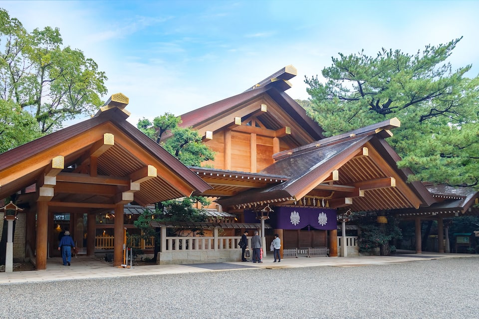 A traditional Japanese building with wooden architecture and a gravel courtyard.