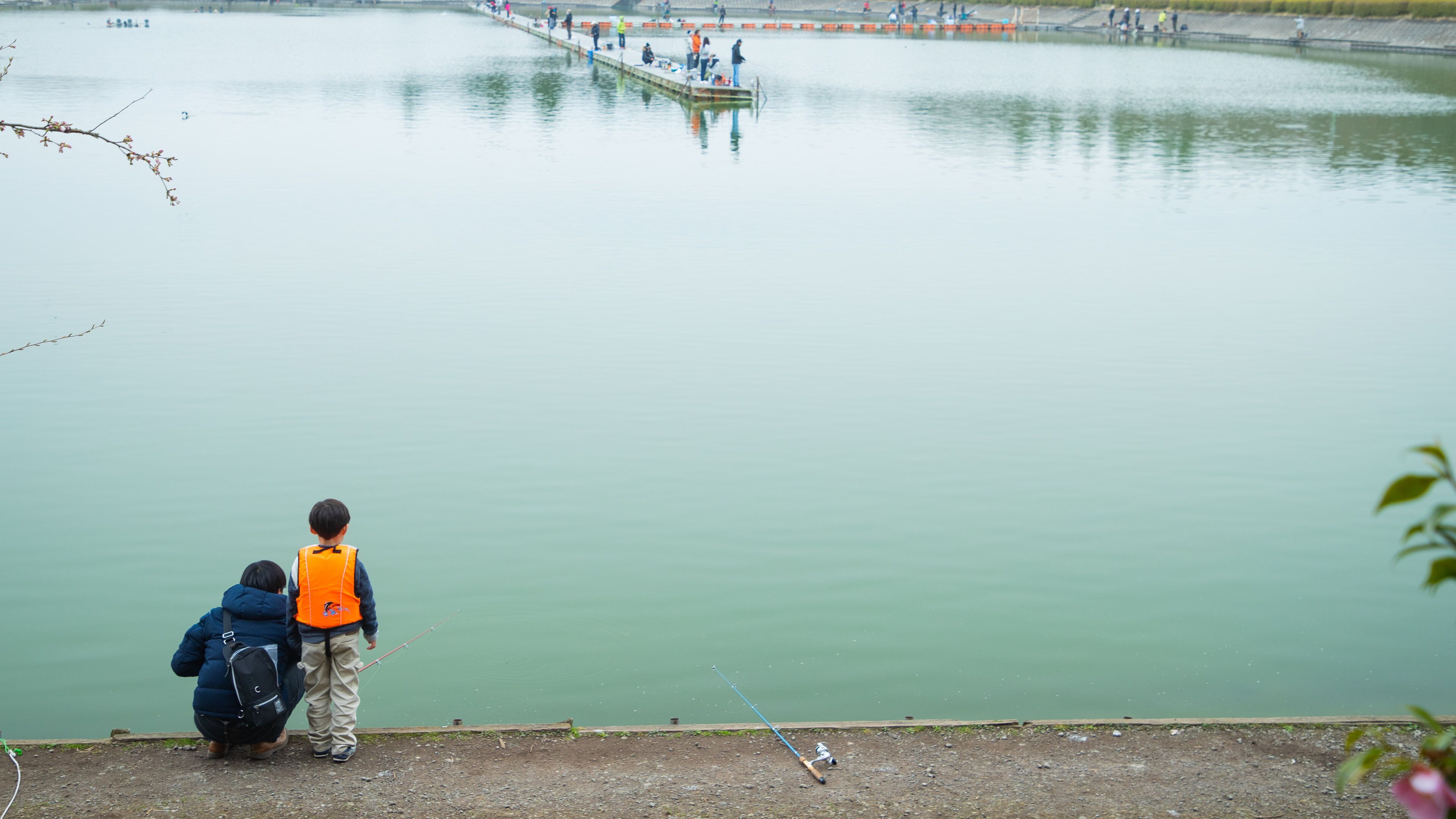 Lake Higashiyama showing fishing and a lake or waterhole as well as a family
