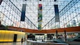 A modern indoor space with a glass ceiling and metal framework.