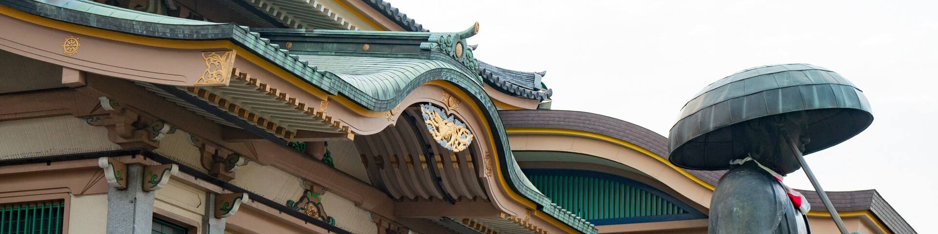 A traditional building with ornate architecture, including a curved roof and decorative elements.