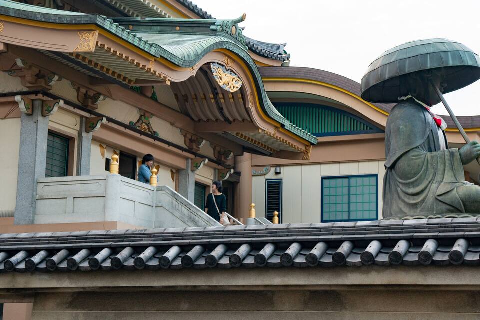 A traditional building with ornate architecture, including a curved roof and decorative elements.