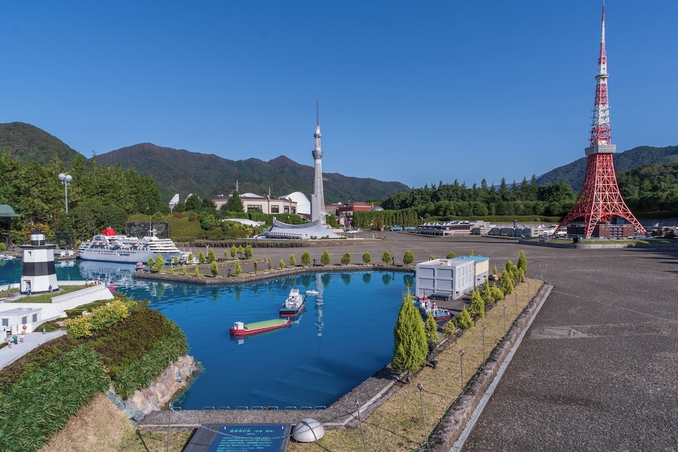 A marina with boats, a replica of the Eiffel Tower, and a large tower structure.