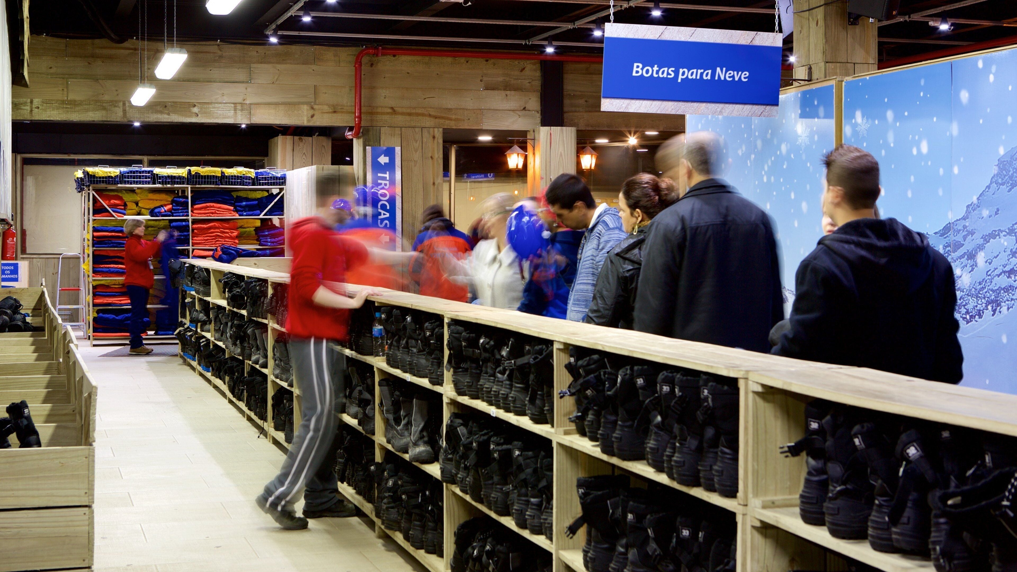 Gramado featuring interior views and signage as well as a small group of people