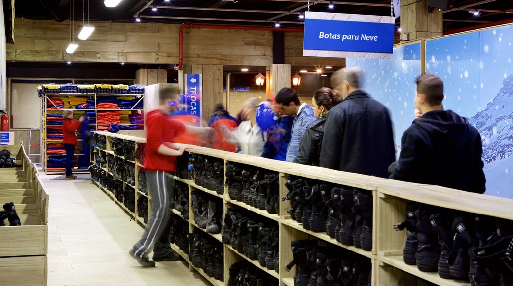 Gramado featuring interior views and signage as well as a small group of people