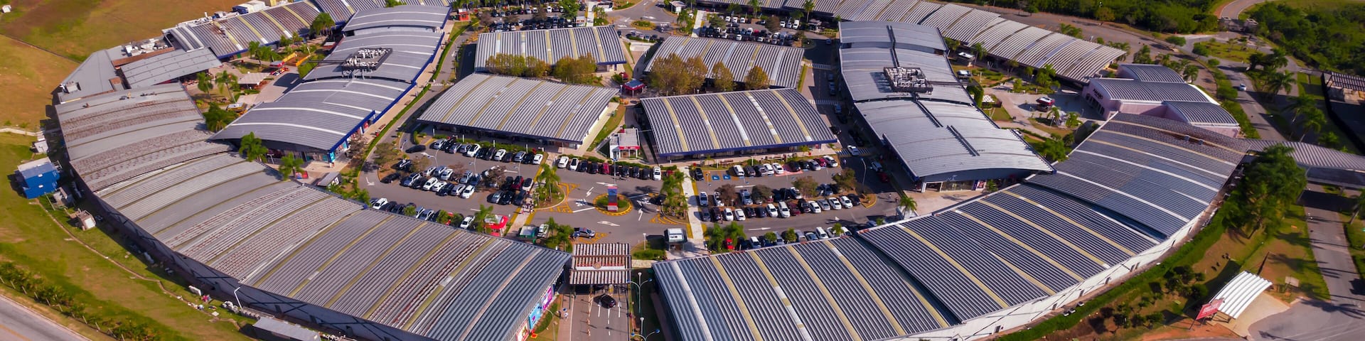 An industrial area with large solar panel arrays and a complex road network.