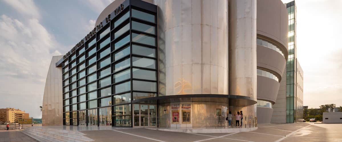 Teatro Auditorio Roquetas de Mar which includes modern architecture and a sunset