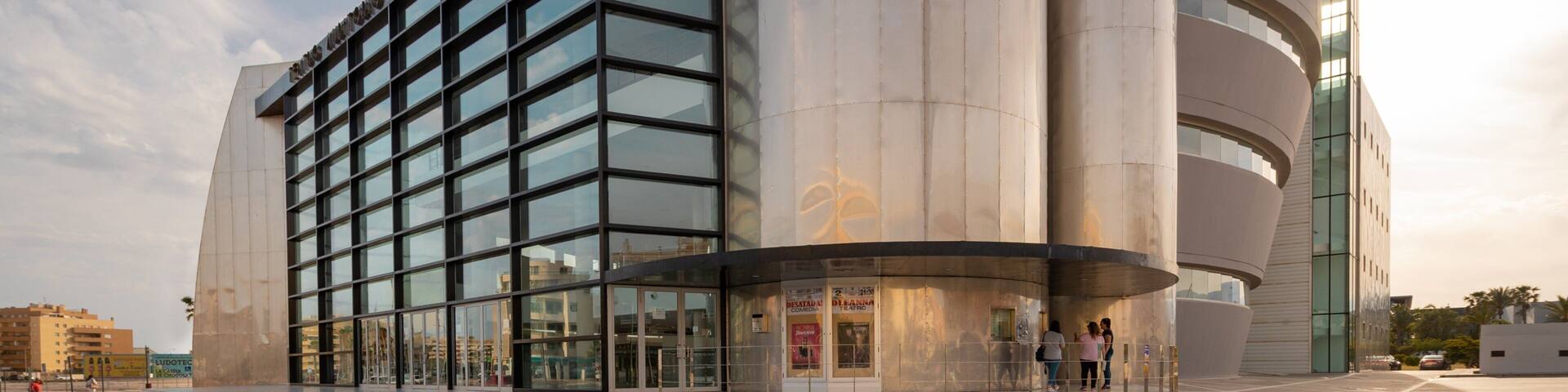 Teatro Auditorio Roquetas de Mar which includes modern architecture and a sunset