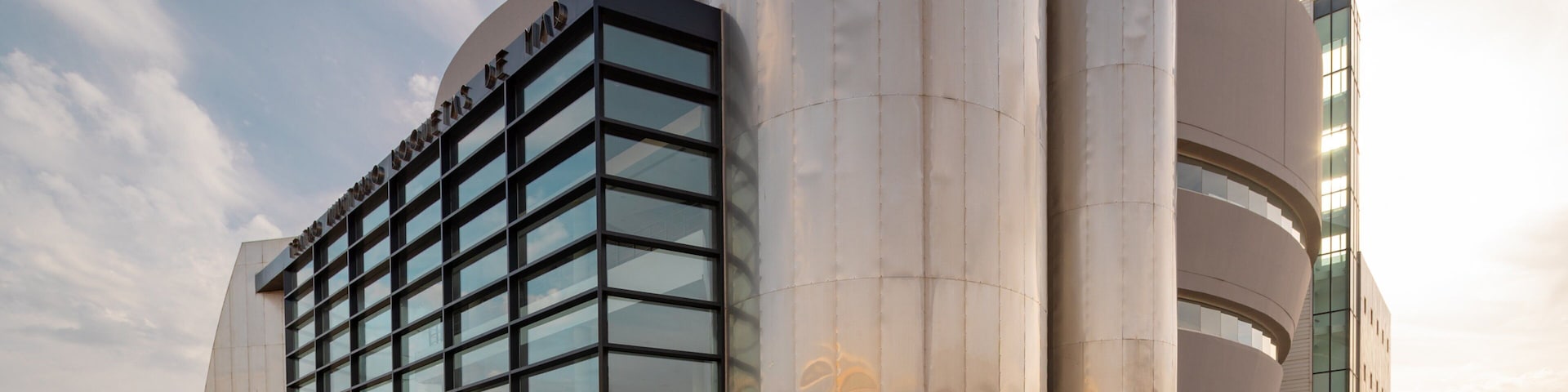 Teatro Auditorio Roquetas de Mar which includes modern architecture and a sunset