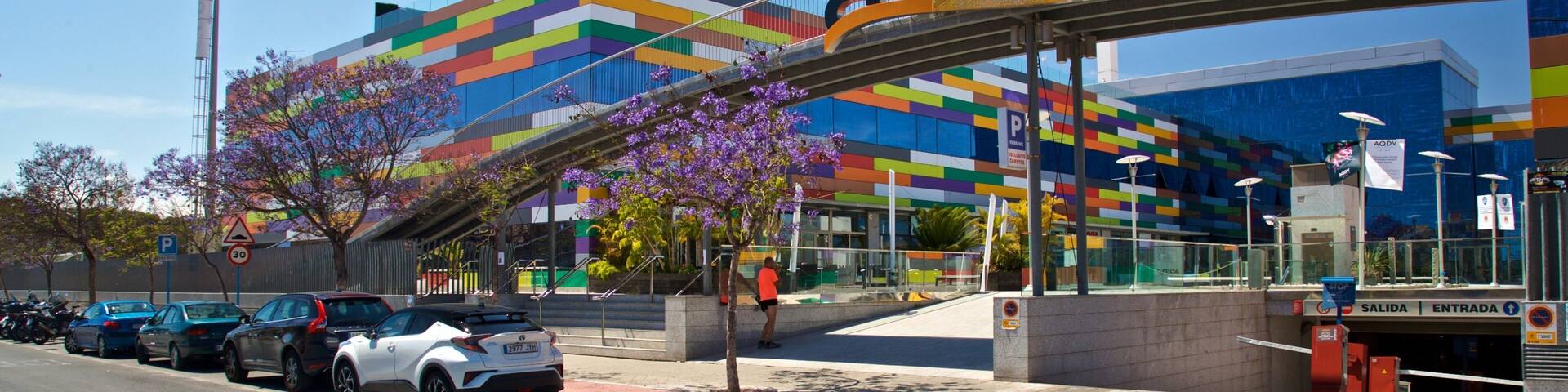 A modern building with a colorful facade and the word "arena" prominently displayed.