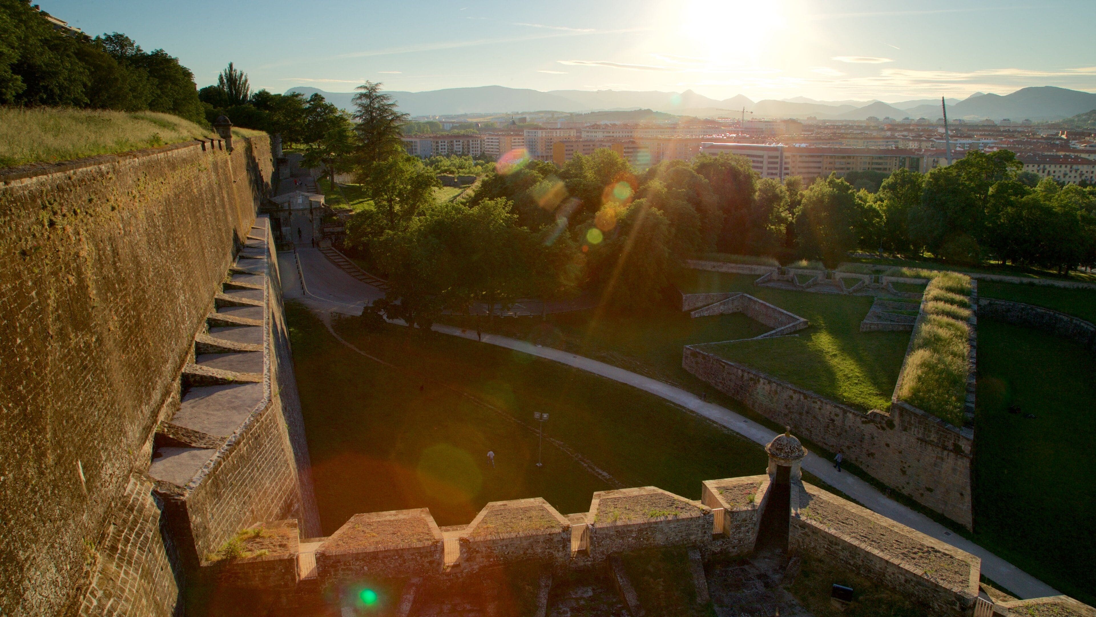 Pamplona\'s City Walls and Interpretation Centre which includes a sunset, landscape views and a garden