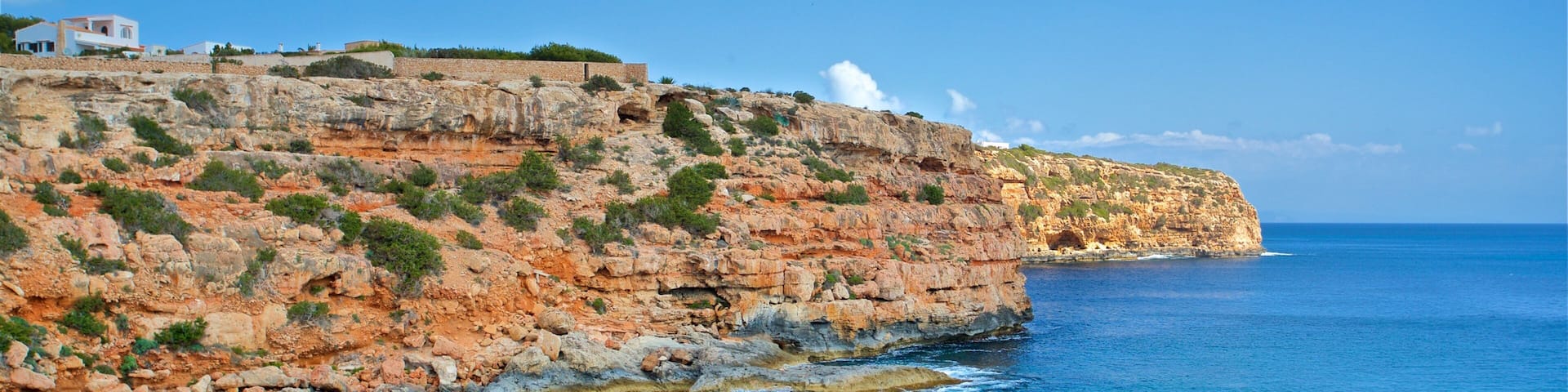 Cala en Baster showing boating, general coastal views and rugged coastline