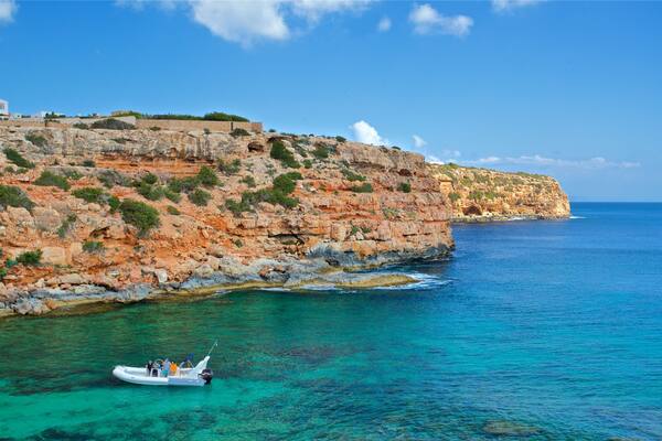 Cala en Baster showing boating, general coastal views and rugged coastline