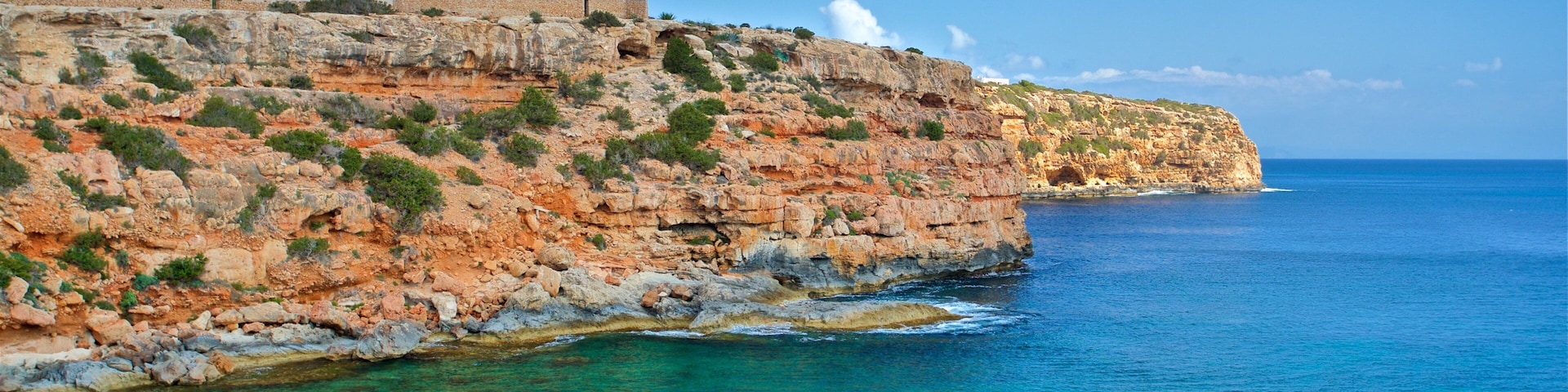 Cala en Baster showing boating, general coastal views and rugged coastline