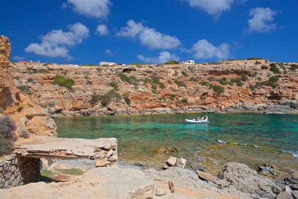 Cala en Baster which includes general coastal views, boating and rugged coastline