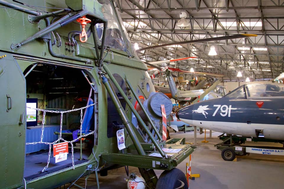 A military aircraft with the number 791 inside a hangar.